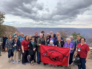 Arkansas travelers enjoying a photogenic moment at the south rim of the Grand Canyon.
